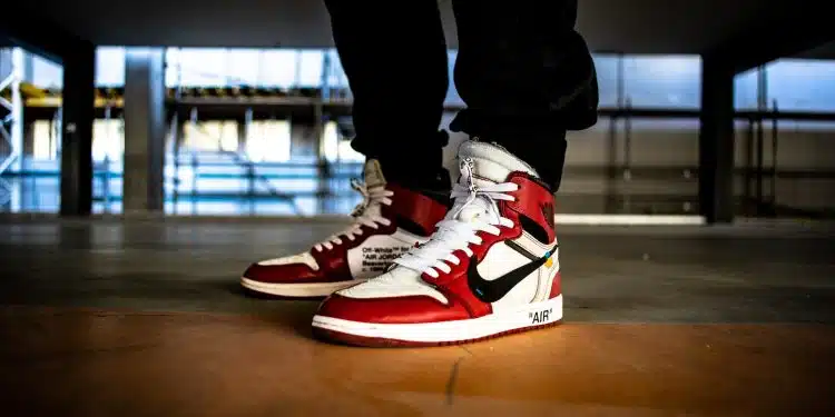 person wearing white-red-and-black Nike X Off-White Air Jordan 1's
