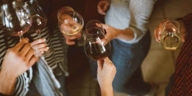 group of people tossing wine glass